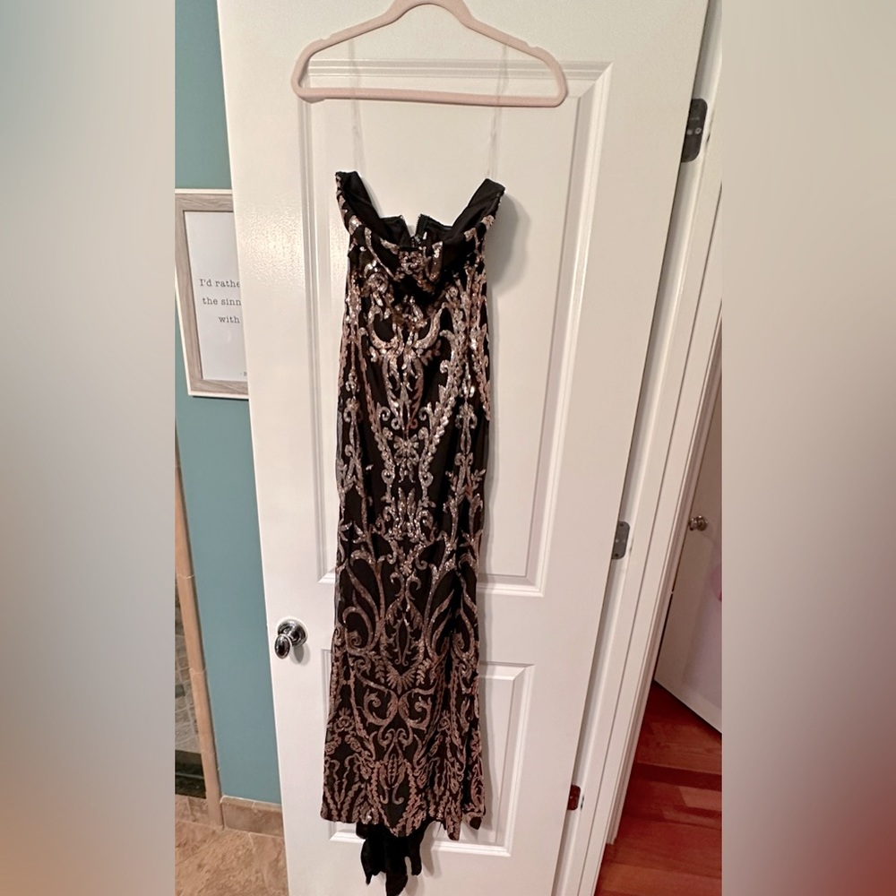 Never been worn floor length black and gold sequenced gown.